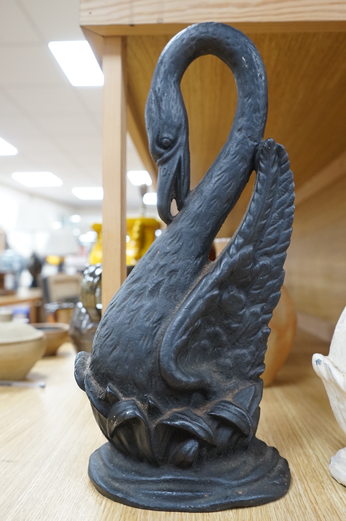 Two Victorian cast iron ‘swan’ door stops, one painted, 38cm